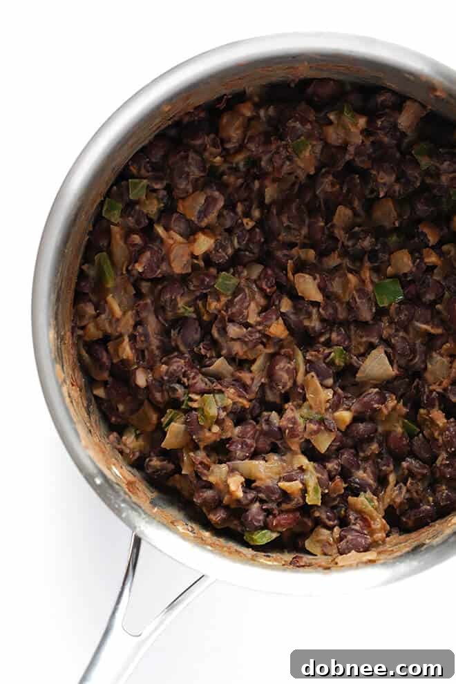 These easy Black Bean Breakfast Tacos are made with a zesty black bean filling, and you can top them with whatever you'd like! | gimmesomeoven.com