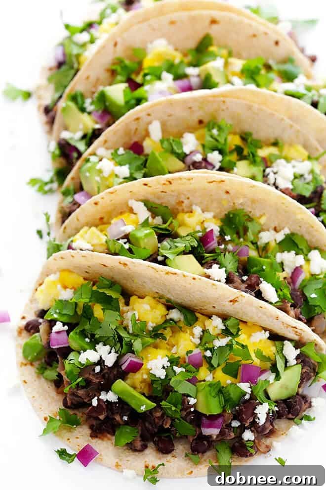 These easy Black Bean Breakfast Tacos are made with a zesty black bean filling, and you can top them with whatever you'd like! | gimmesomeoven.com