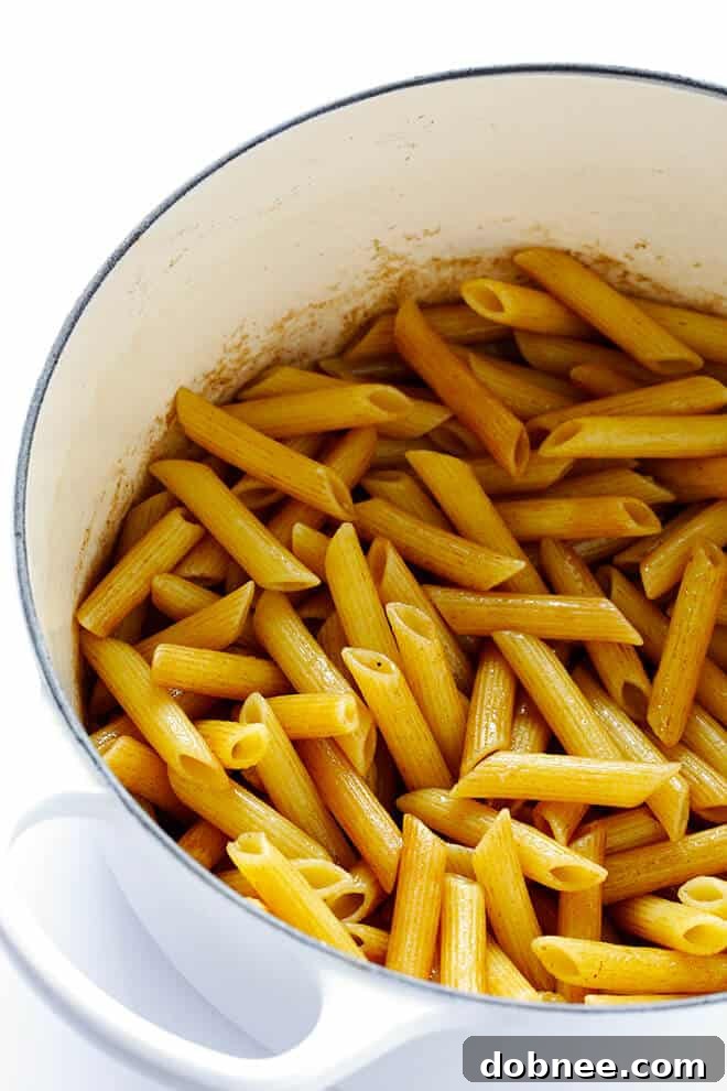 Simple Balsamic Garden Pasta 5 Various chopped fresh vegetables including red onion, asparagus, broccoli, and red bell pepper in a large sauté pan, ready to be cooked for the pasta dish.