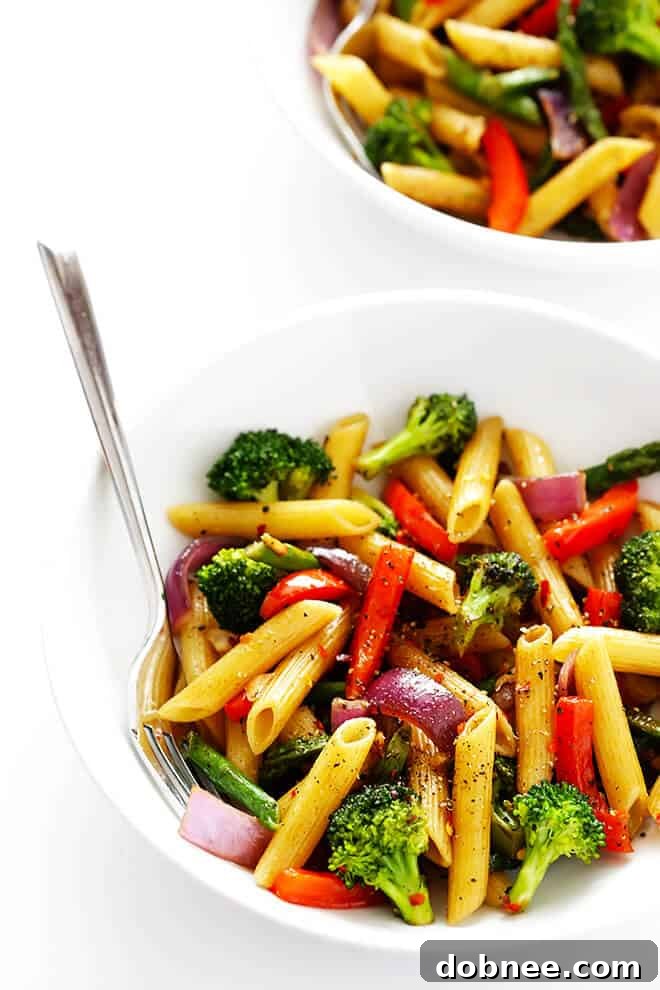 Simple Balsamic Garden Pasta 7 Balsamic Veggie Pasta being stirred in a large pot, showing the pasta and vegetables thoroughly coated in the sauce, ready for serving.