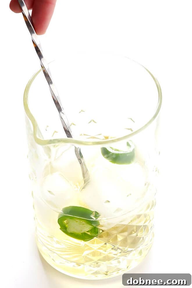 This easy cocktail is made with mezcal, Drambuie, orange bitters, jalapeno, and orange peel. The perfect blend of smoky, spicy, citrusy, and slightly-sweet -- so good!! | gimmesomeoven.com