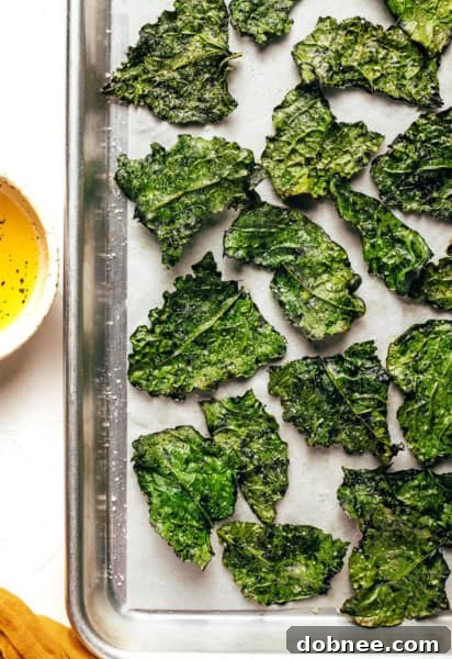 Crispy homemade kale chips artfully arranged in a bowl, ready to be served.