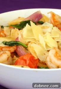 A vibrant bowl of homemade Pasta Fresca with fresh shrimp, tomatoes, and spinach.