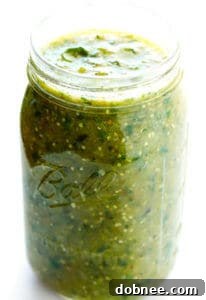 Homemade Roasted Tomatillo Salsa Verde, a vibrant green sauce, prepared and ready to be served.