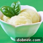 Close-up of a vibrant Basil Lime Sorbet in a bowl, garnished with fresh basil. An ideal light and refreshing dessert.