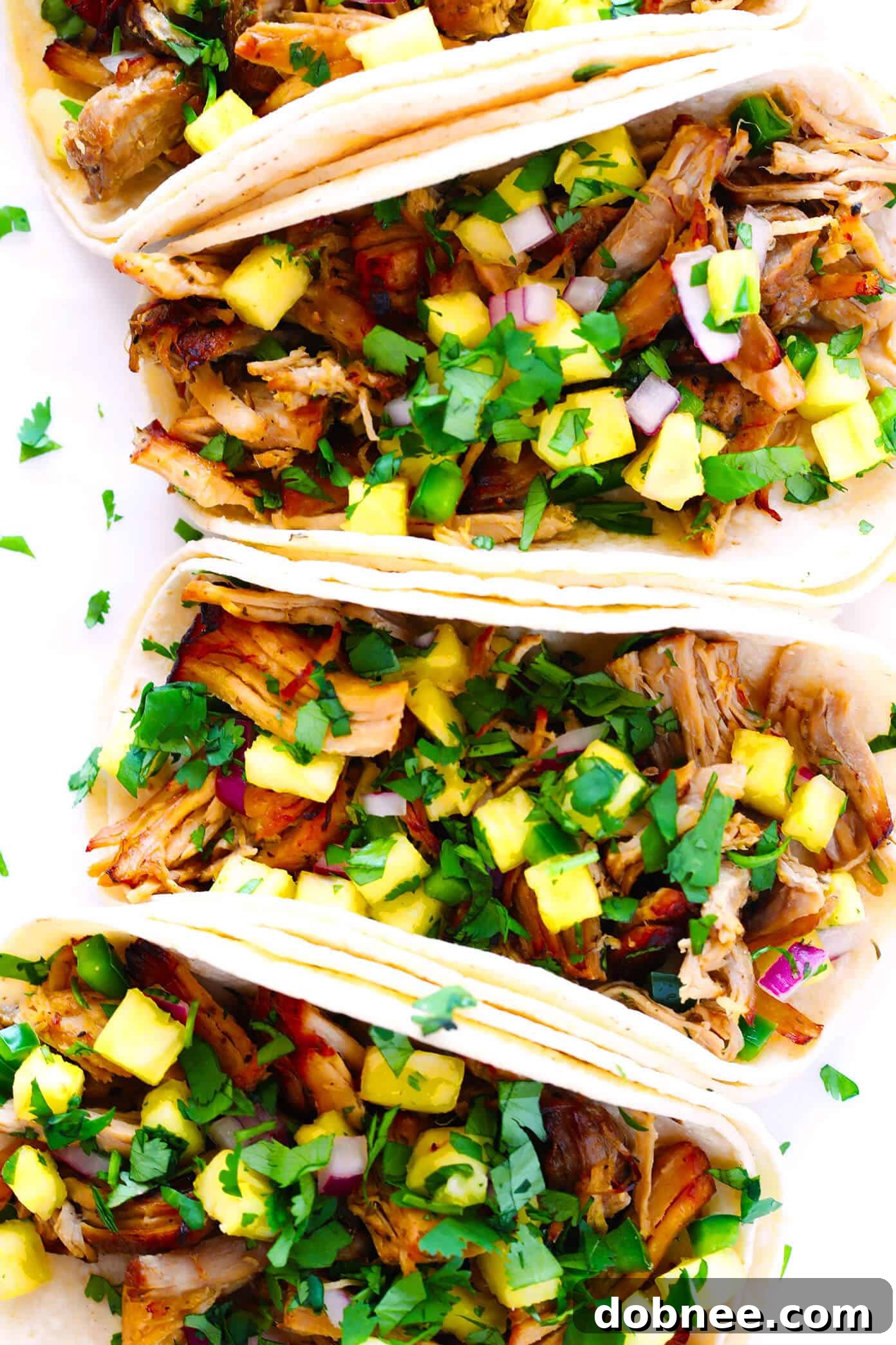 Carnitas Tacos - Delicious Instant Pot Carnitas served in soft corn tortillas.