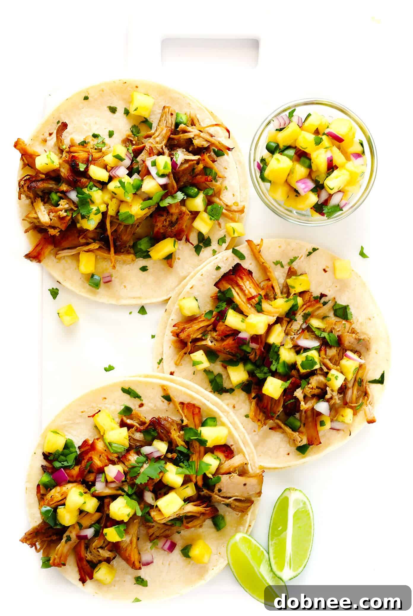 Pork Carnitas Tacos - A close-up of delicious crispy pork carnitas in tacos.