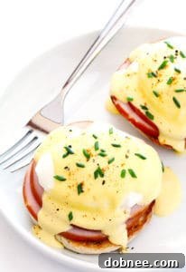 Close-up of a perfectly poached egg with a bright yellow yolk, ready to be served.