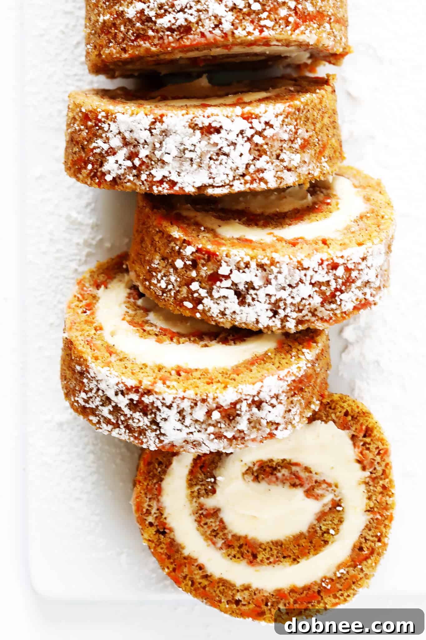 This Carrot Cake Roll recipe is easy to make, and filled with the most amazing cream cheese frosting. It's the perfect dessert for Easter, Spring, or anytime you're craving carrot cake! | gimmesomeoven.com