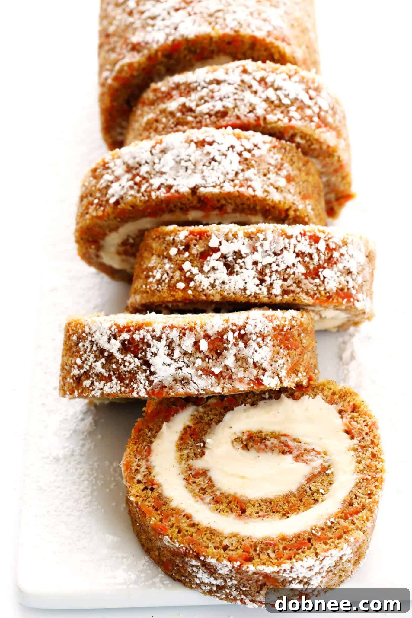 Everything you love about carrot cake...rolled up with cream cheese filling into this delicious Carrot Cake Roll! Such a fun dessert! | gimmesomeoven.com