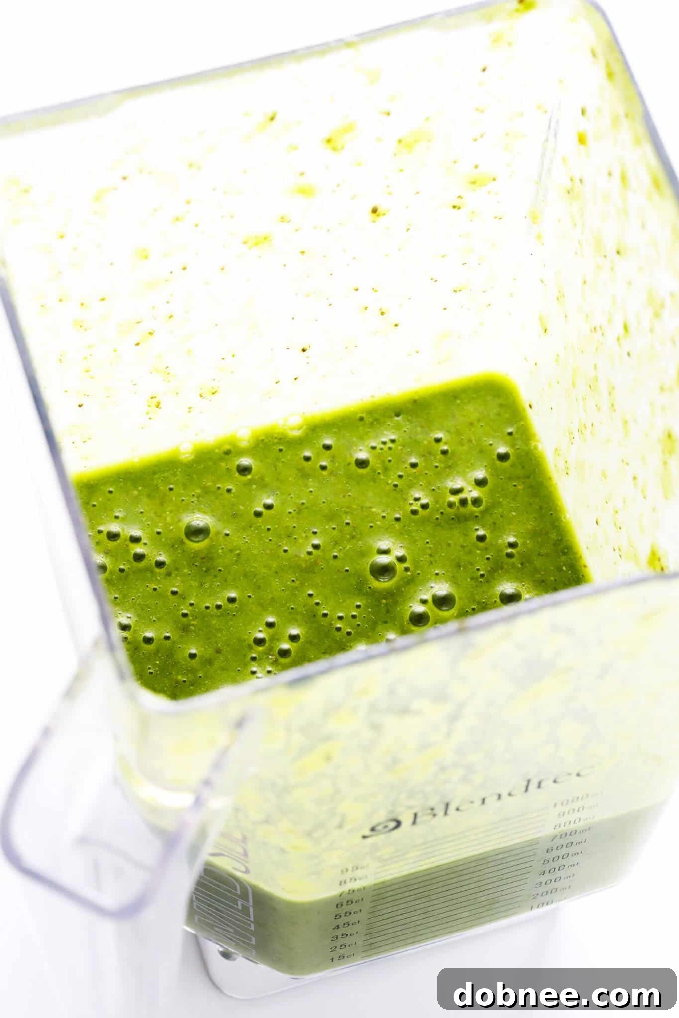All the fresh ingredients for the Matcha Ginger Green Smoothie precisely measured and ready in a blender before mixing.