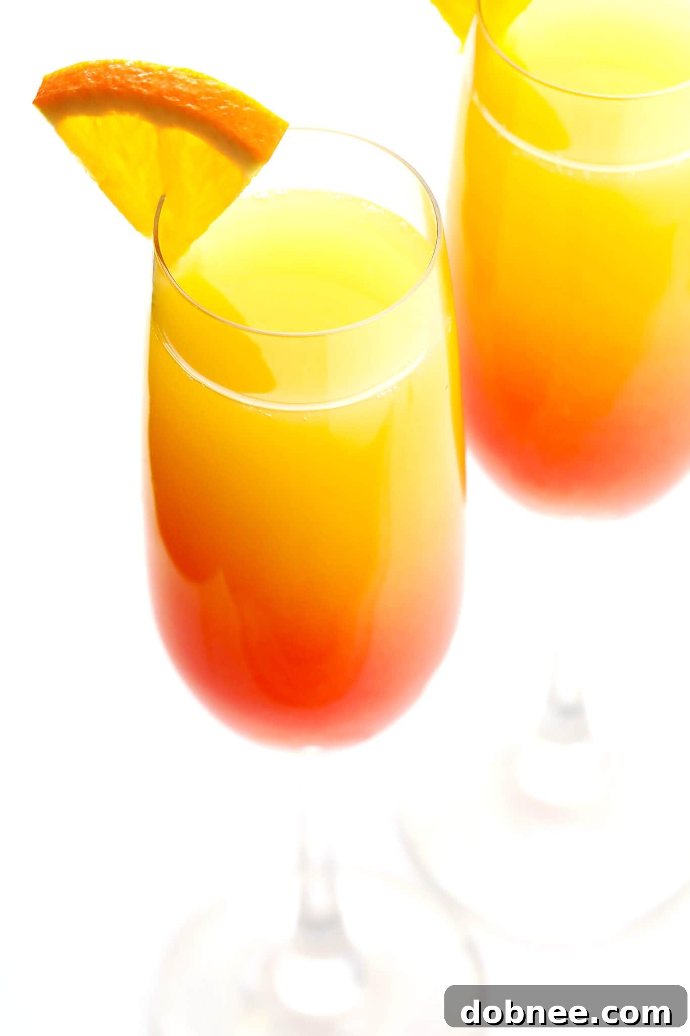 Agave Dawn Mimosa 6 A beautifully crafted Tequila Sunrise Mimosa cocktail in a flute, ready to be enjoyed.