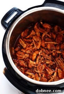 A plate of Instant Pot BBQ Pulled Pork with a side of slaw.