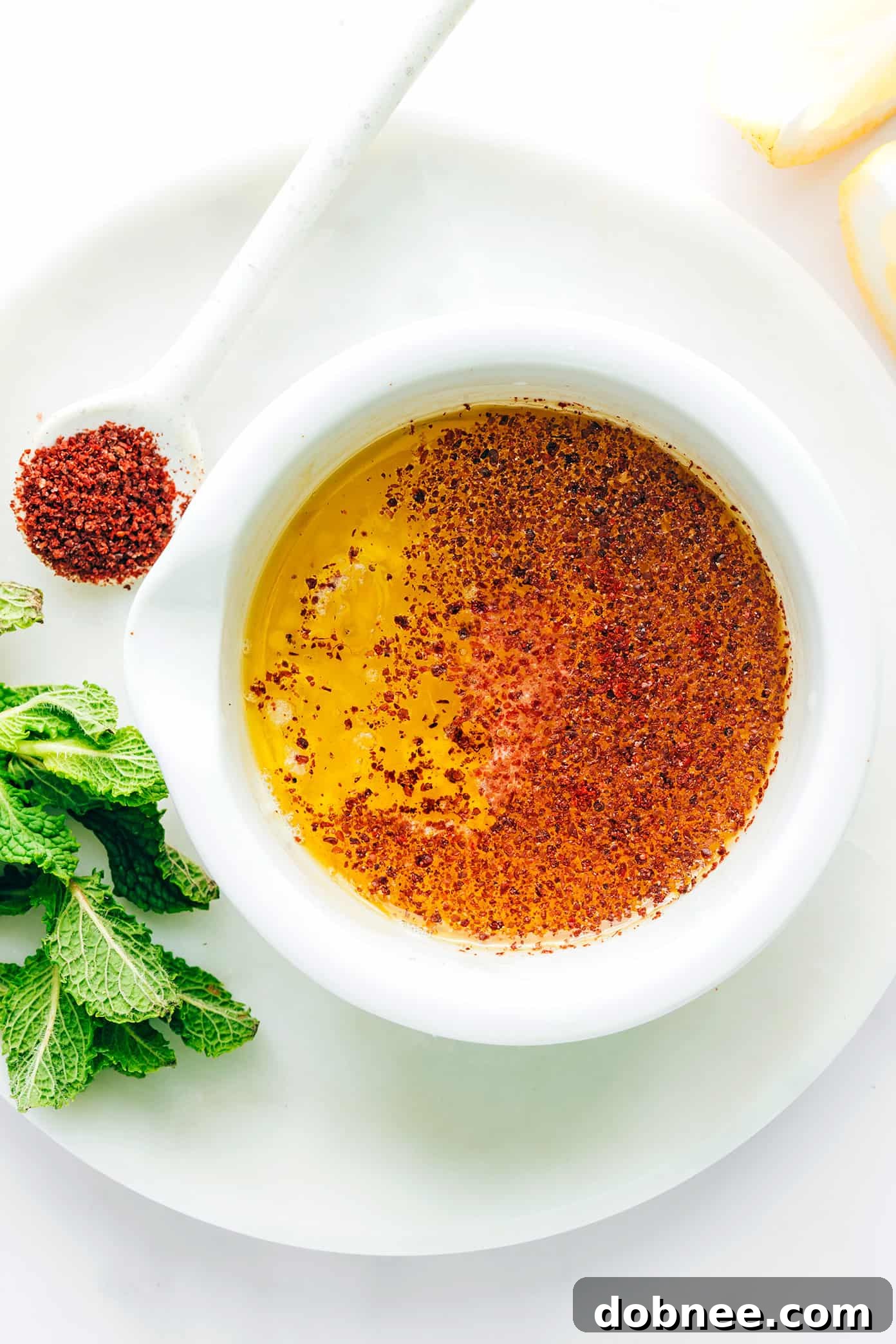 Refreshing Fattoush Salad 4 Fattoush Salad being tossed in a large mixing bowl with dressing.