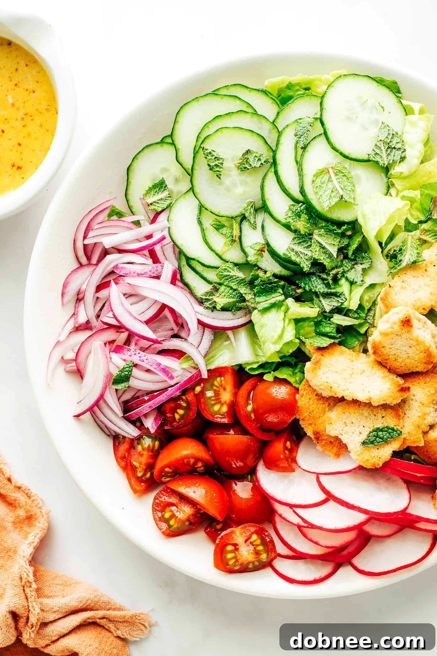 Refreshing Fattoush Salad 5 A beautifully presented bowl of Fattoush Salad, garnished with fresh herbs and more pita chips.