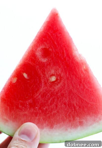 Watermelon salsa with tortilla chips on a white platter