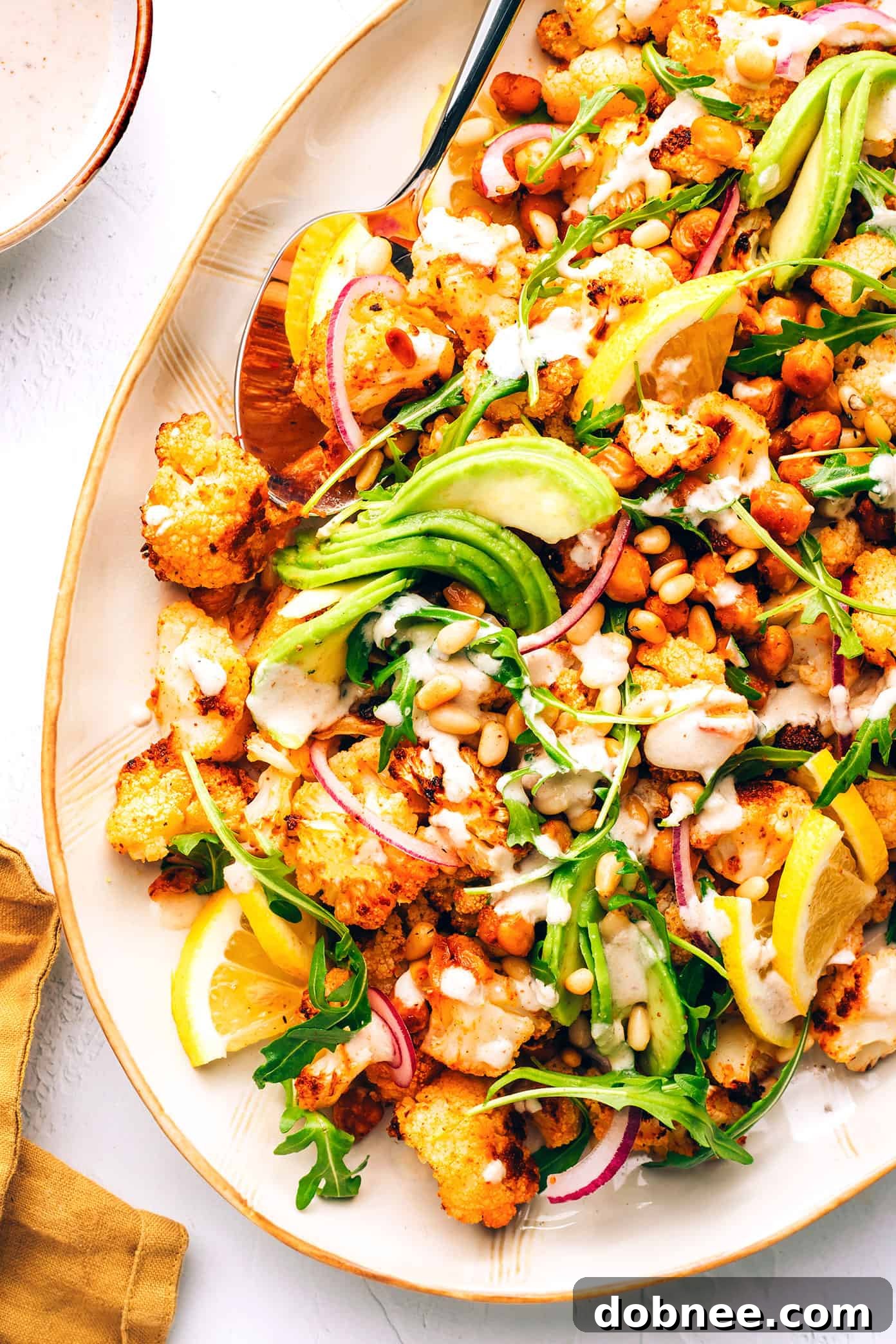 Array of various healthy and fresh salad recipes laid out on a table