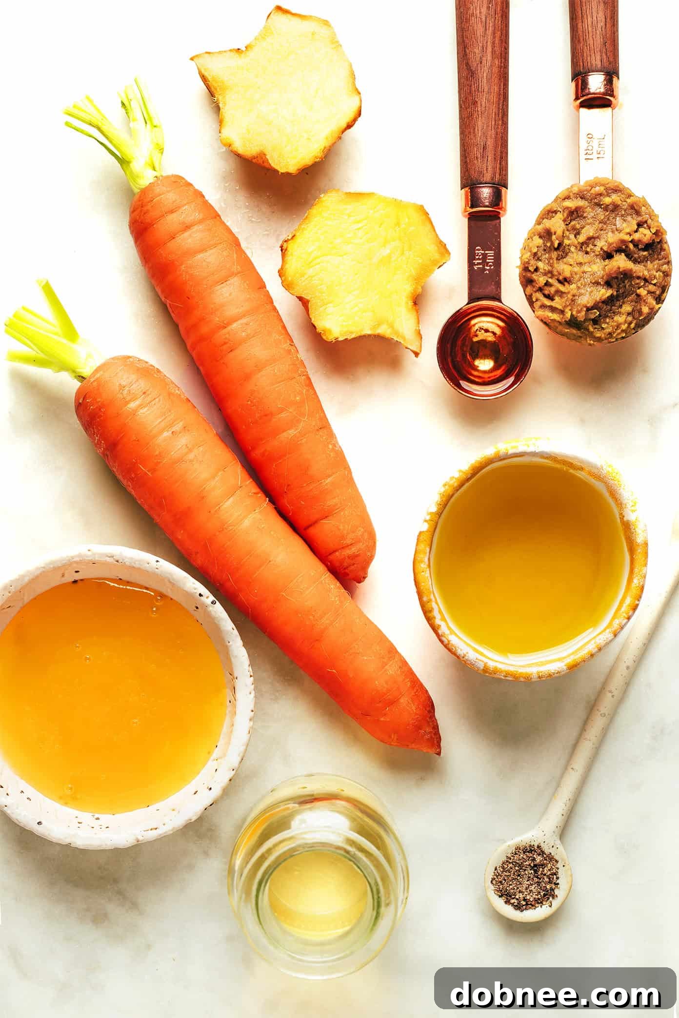 A bowl of fresh green salad drizzled with homemade carrot ginger dressing