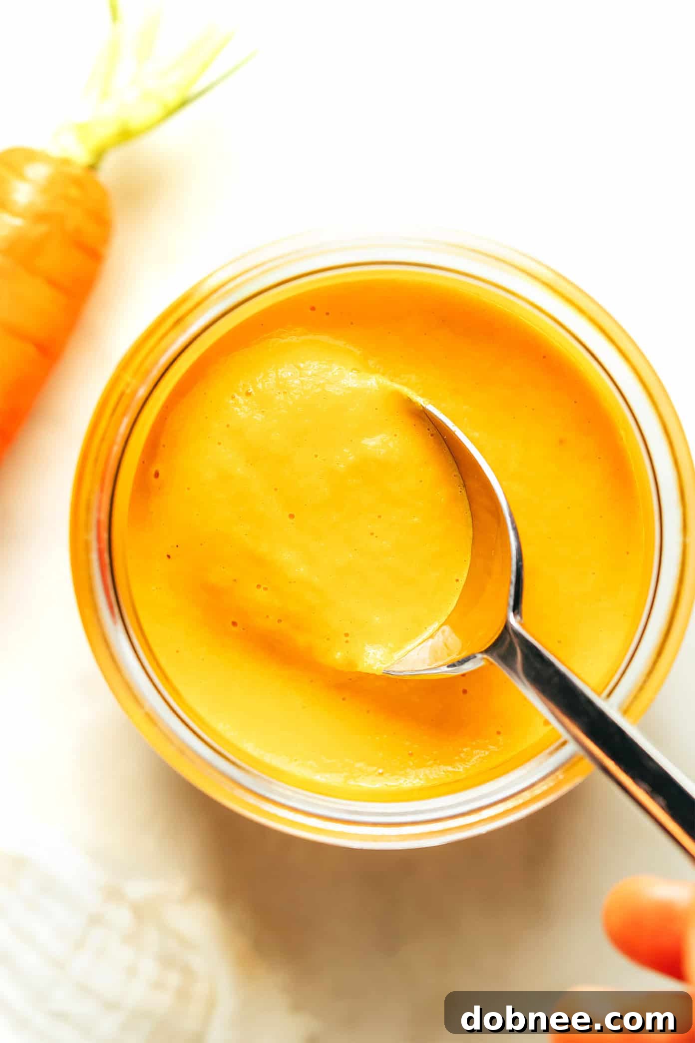 Ingredients for carrot ginger dressing: fresh carrots, ginger root, honey, and a bottle of oil