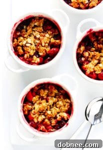 Delicious Cranberry Crisp topped with vanilla ice cream, served in a mini ramekin