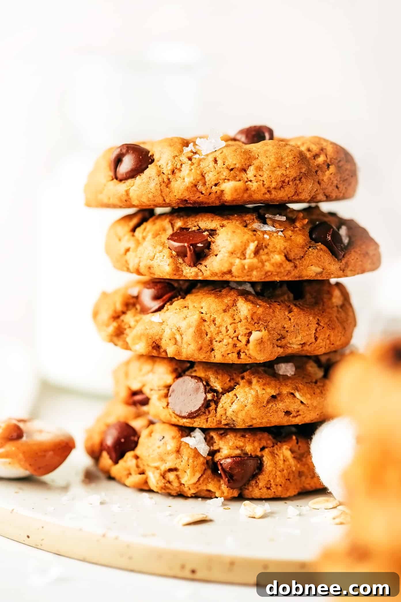 A stack of healthy peanut butter chocolate chip cookies on a cooling rack