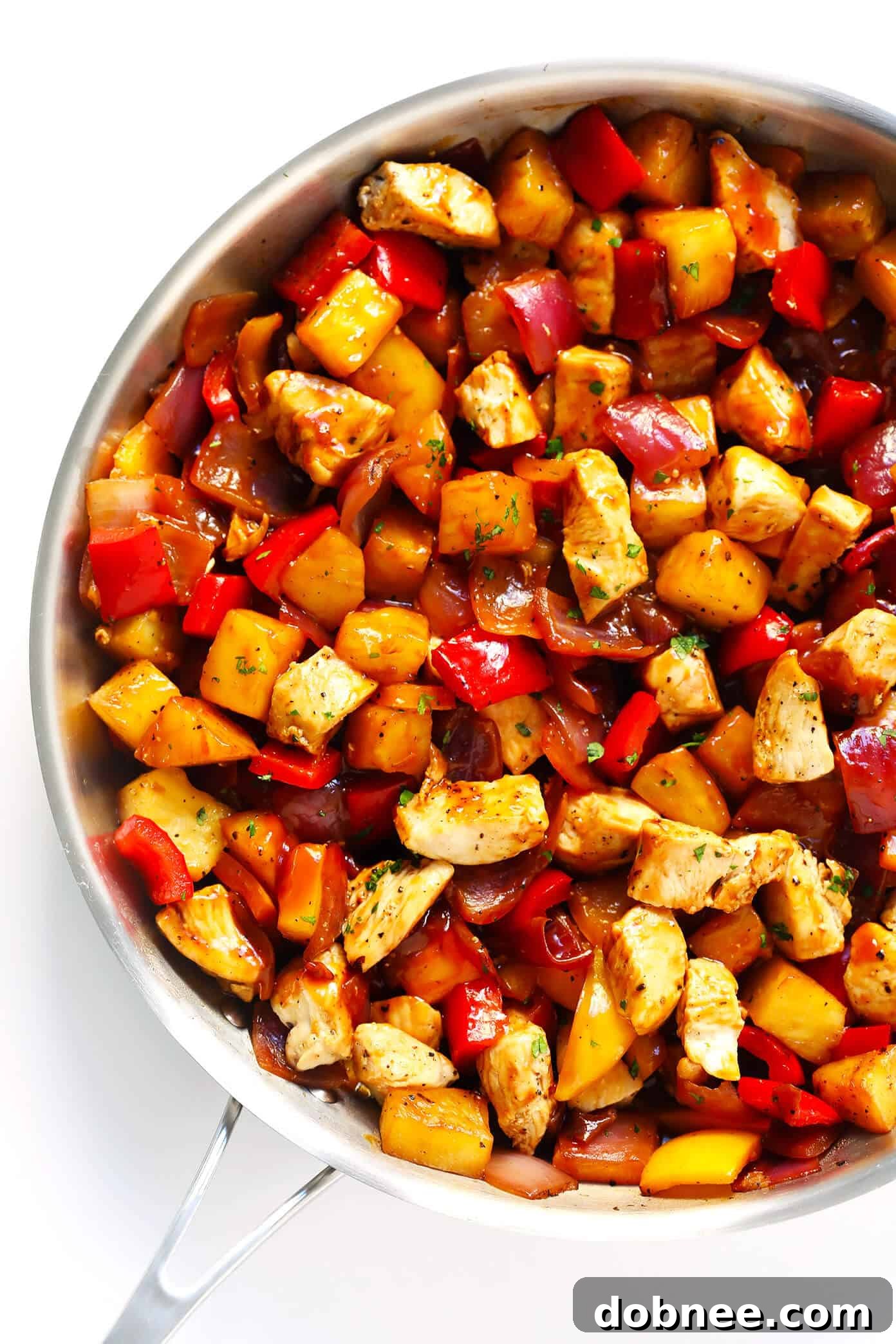 A vibrant Hawaiian BBQ Chicken Bowl with juicy chicken, colorful bell peppers, and fresh pineapple chunks, ideal for healthy lunches or dinners.