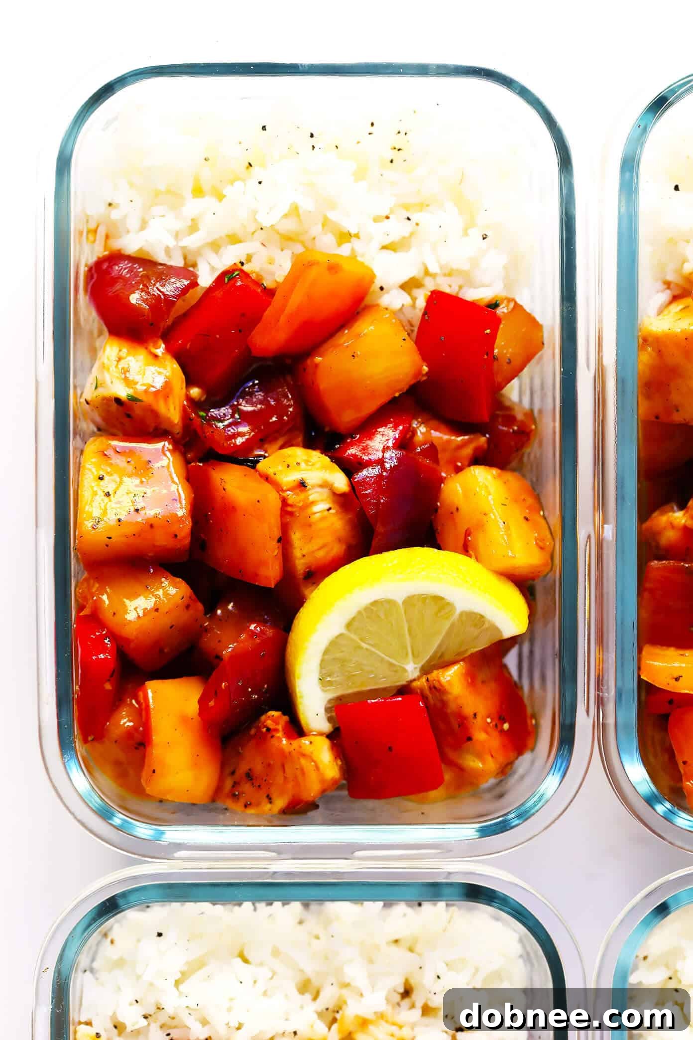 Five meal prep containers filled with Hawaiian BBQ Chicken Bowls, ready for a week of healthy, easy meals.