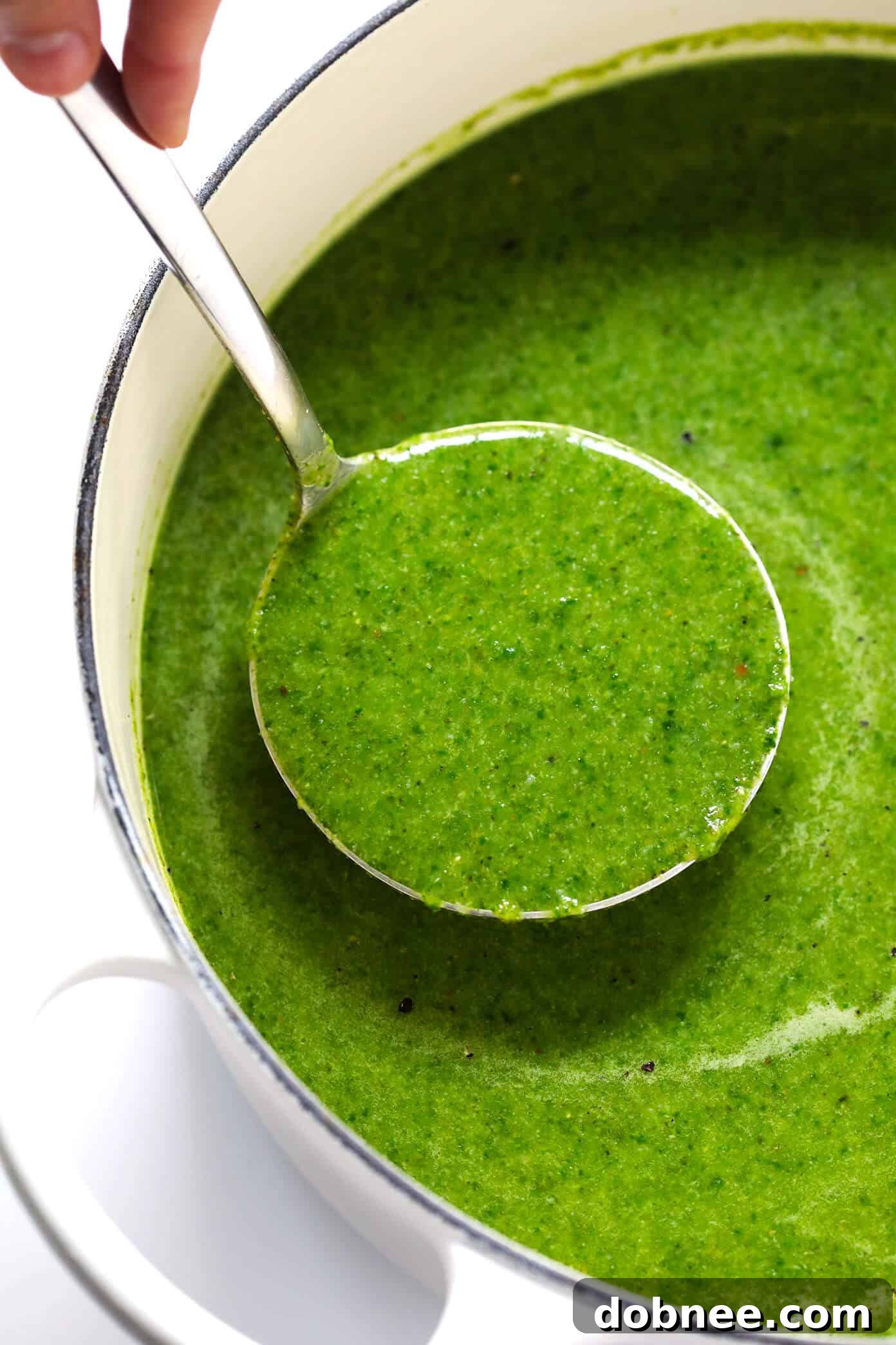 Creamy Green Goddess Soup being pureed with an immersion blender in a pot
