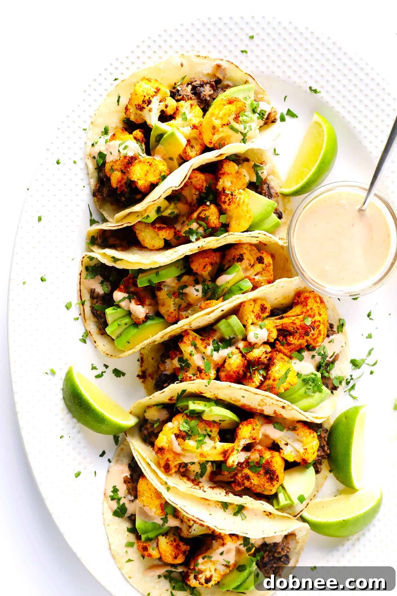 Flavorful Roasted Cauliflower and Black Bean Tacos with Zesty Crema - Vegan & Gluten-Free