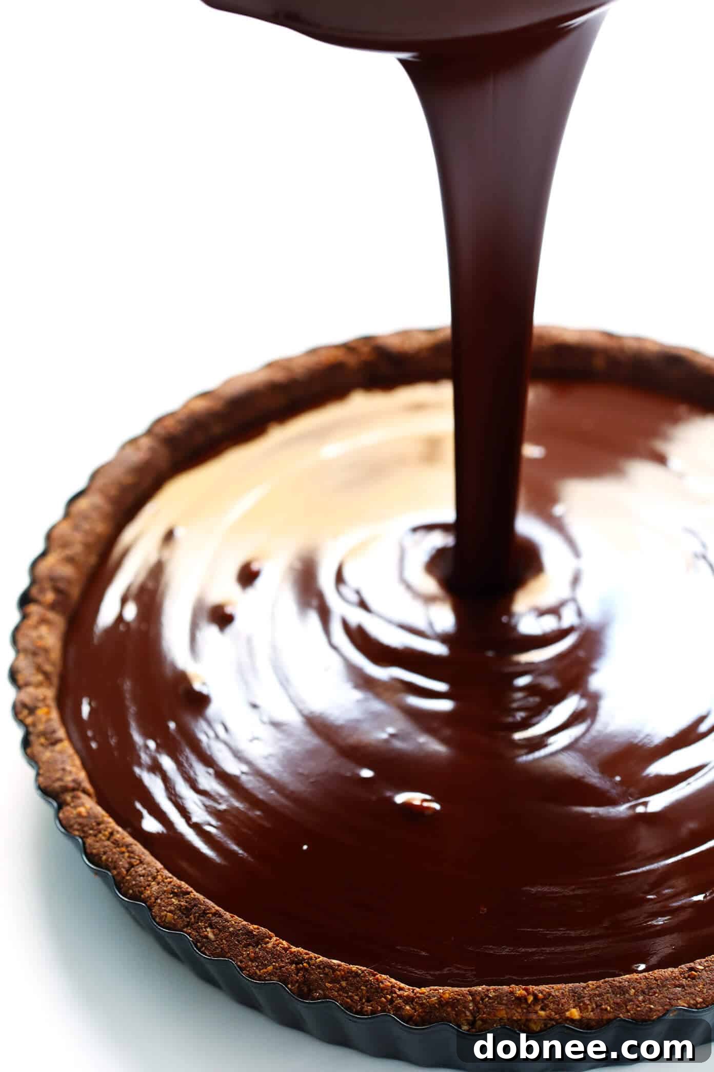 Pouring Dark Chocolate Filling into a Baked Tart Crust