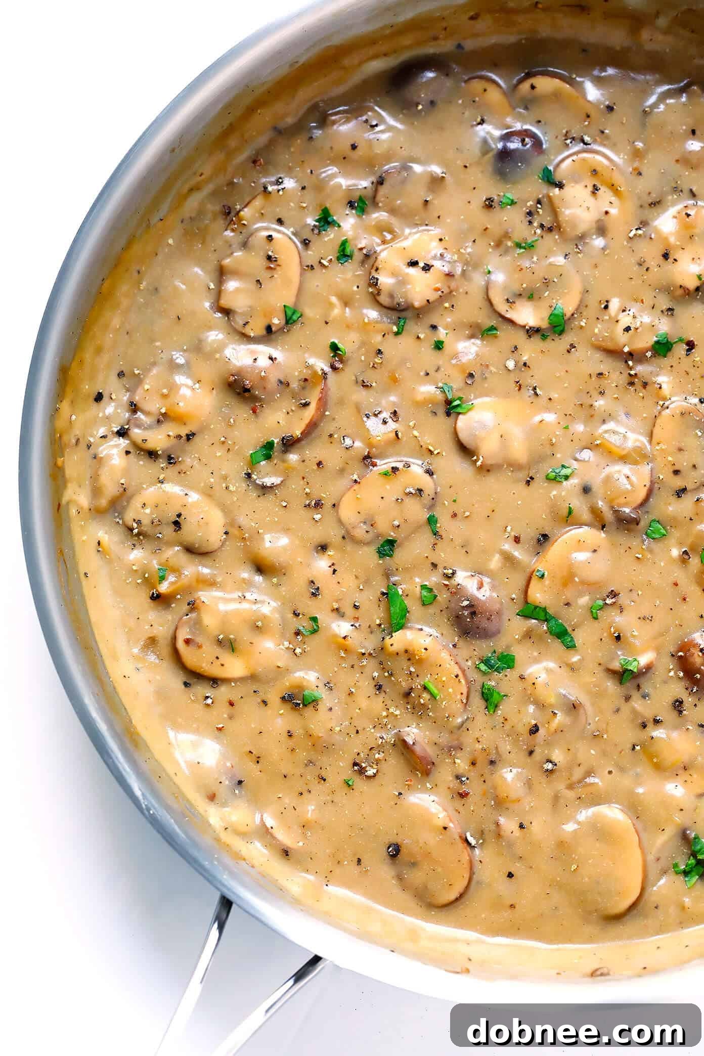 Vegetarian Mushroom Stroganoff Sauce, rich and creamy, simmering in a pan, ready to be combined with noodles.