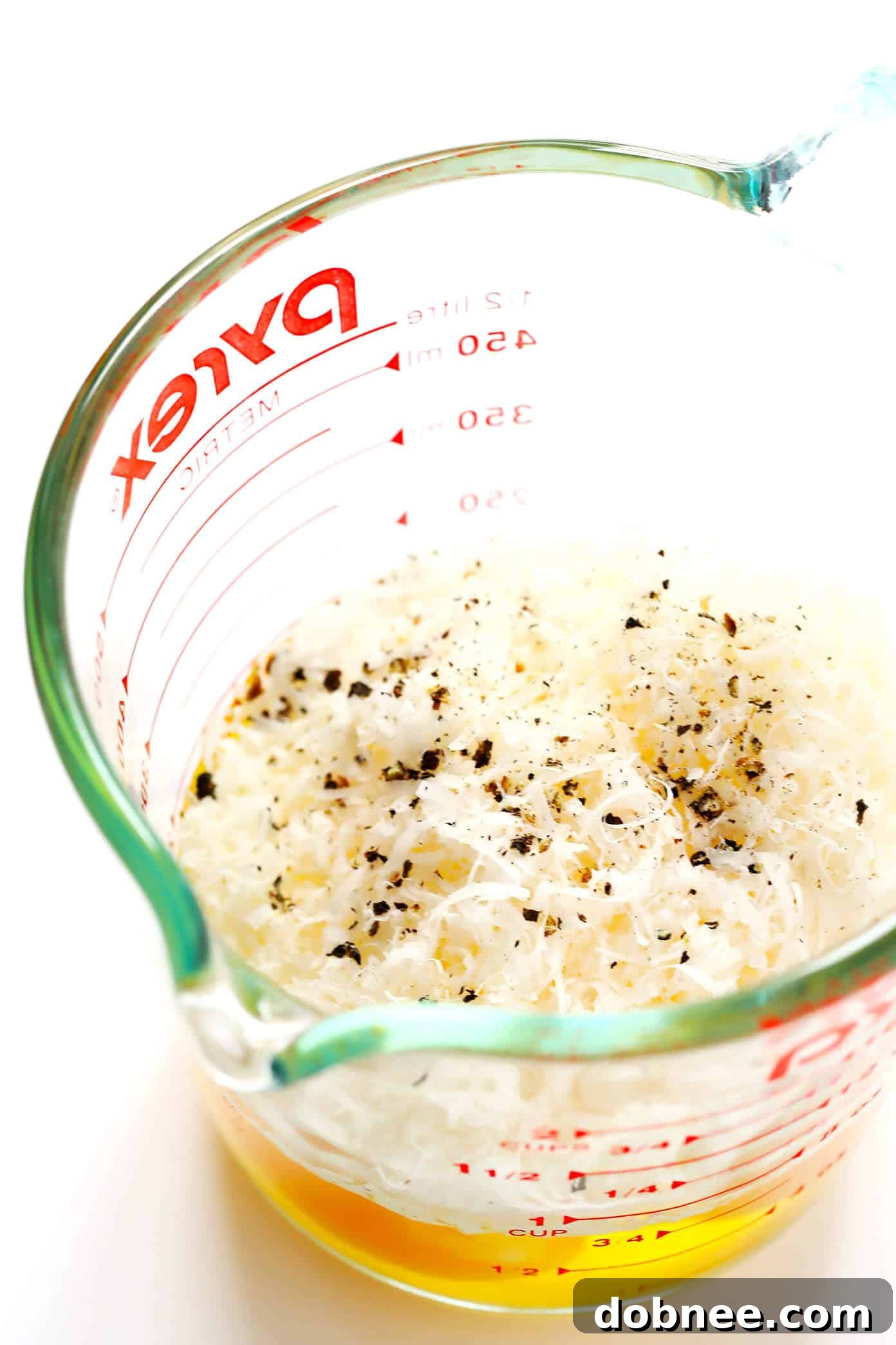 Whisked eggs and freshly grated Manchego cheese, key ingredients for a creamy Spanish Carbonara sauce