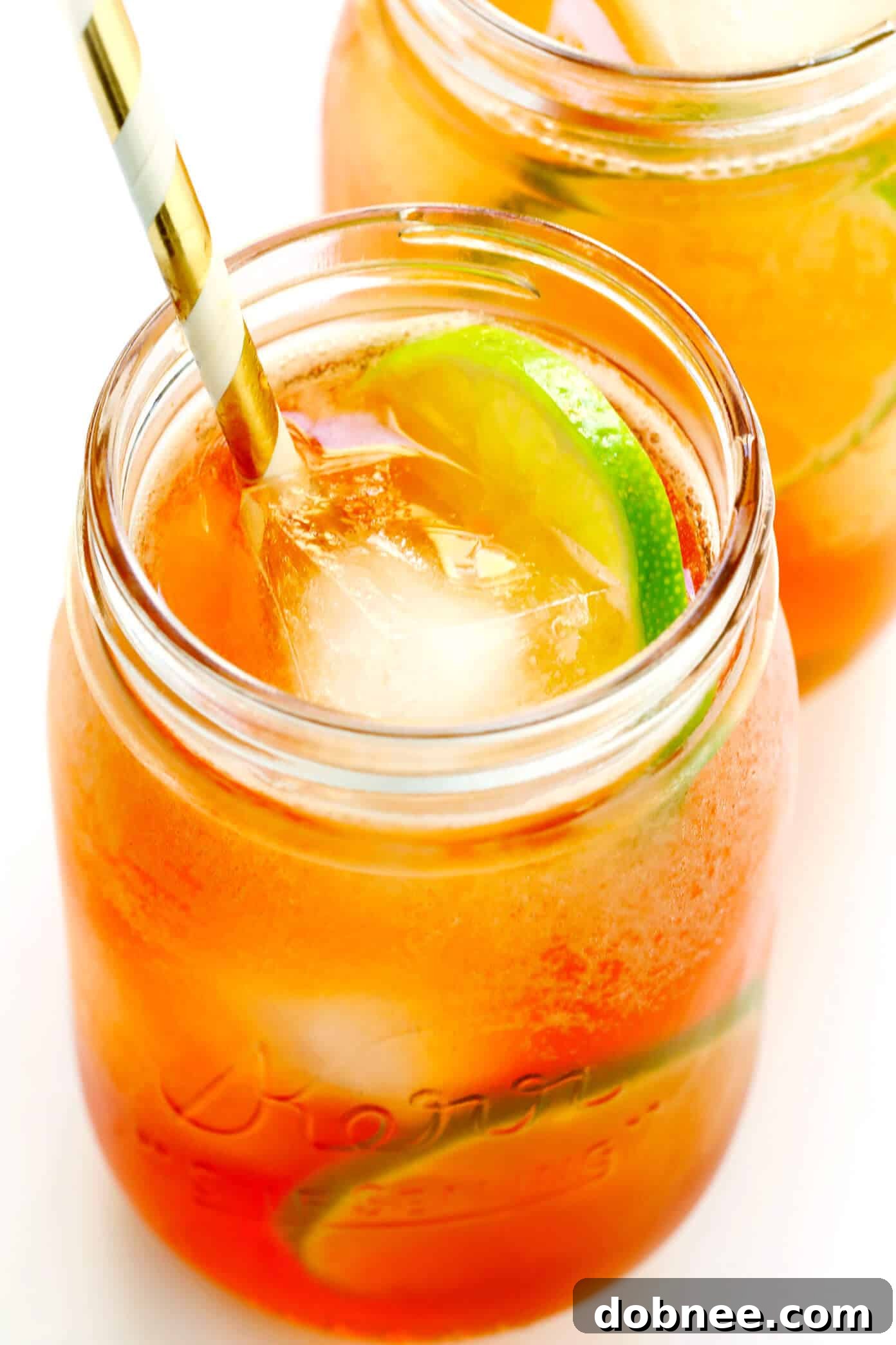 Mixing a refreshing Horsefeather Cocktail in a highball glass with ice, whiskey, ginger beer, and bitters