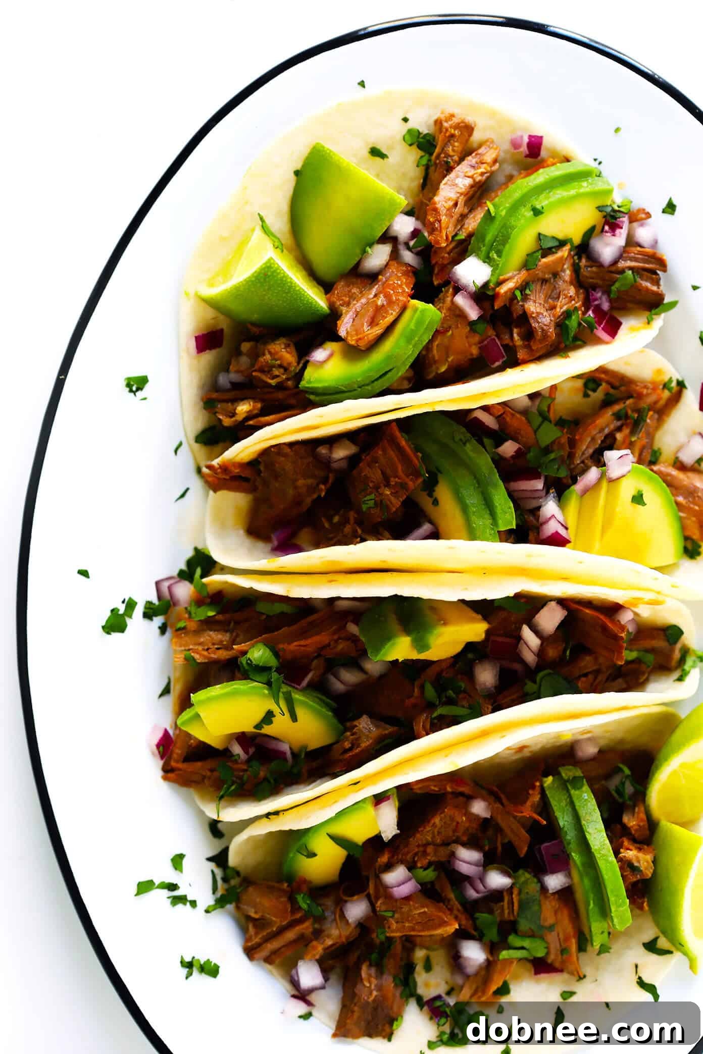 Savor this Instant Pot Barbacoa Beef recipe! It's easy to make, packed with flavor, and ideal for tacos, burritos, and more. A perfect Mexican instant pot recipe. Instant Pot Barbacoa Beef Tacos, served with fresh cilantro and lime