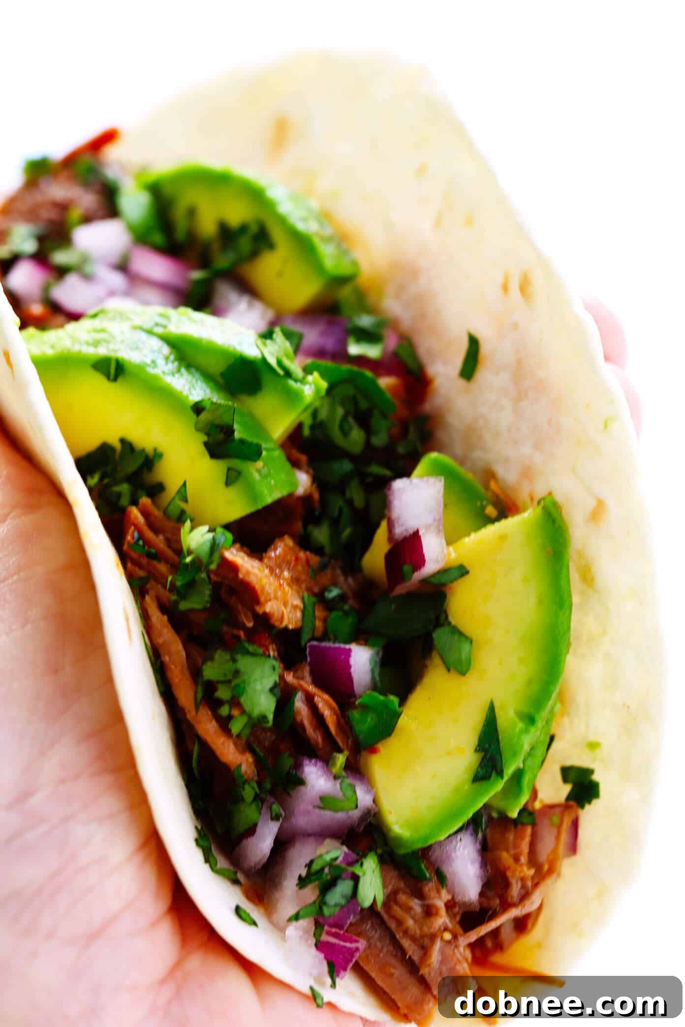 Tender Instant Pot Barbacoa Beef 2 A bowl of shredded Instant Pot Barbacoa Beef, glistening with rich juices