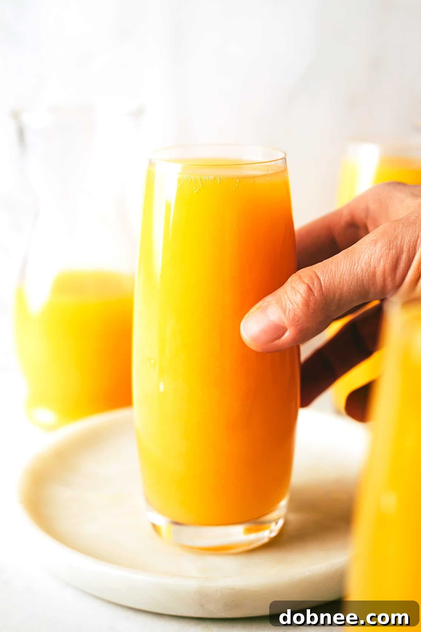 Two glasses of classic mimosas with orange slices, bright and refreshing