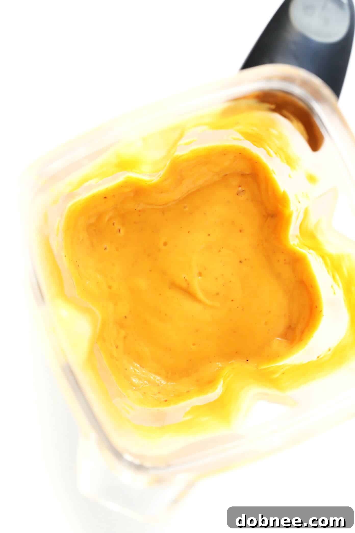 Blender filled with ingredients for Red Curry Sauce, showing the creamy texture