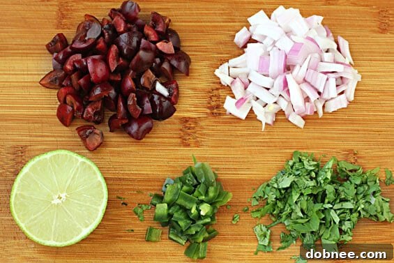 Close-up of Grilled Tilapia with Cherry Salsa on a plate, garnished with fresh cilantro