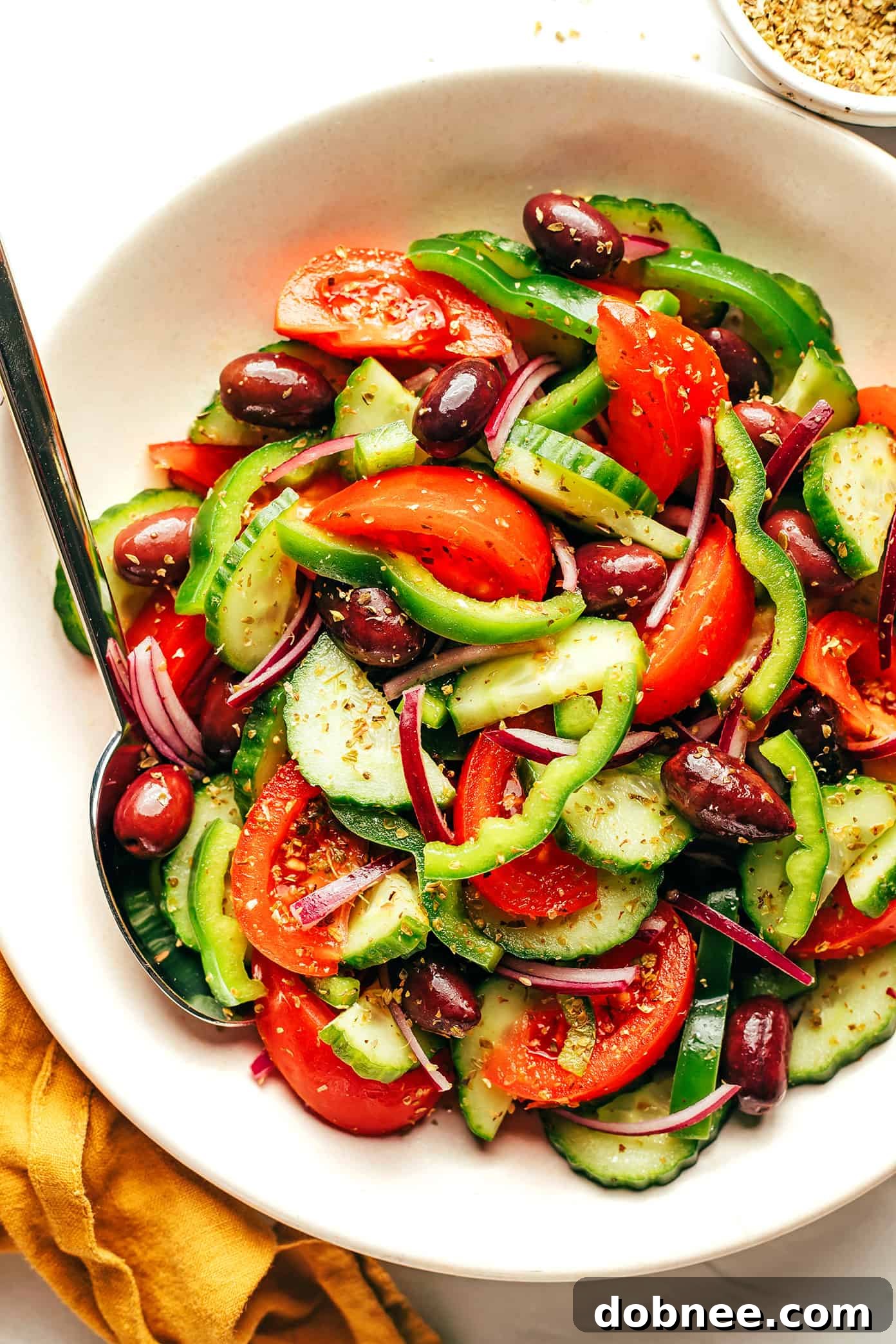 Authentic Greek Salad with fresh vegetables and a block of feta cheese