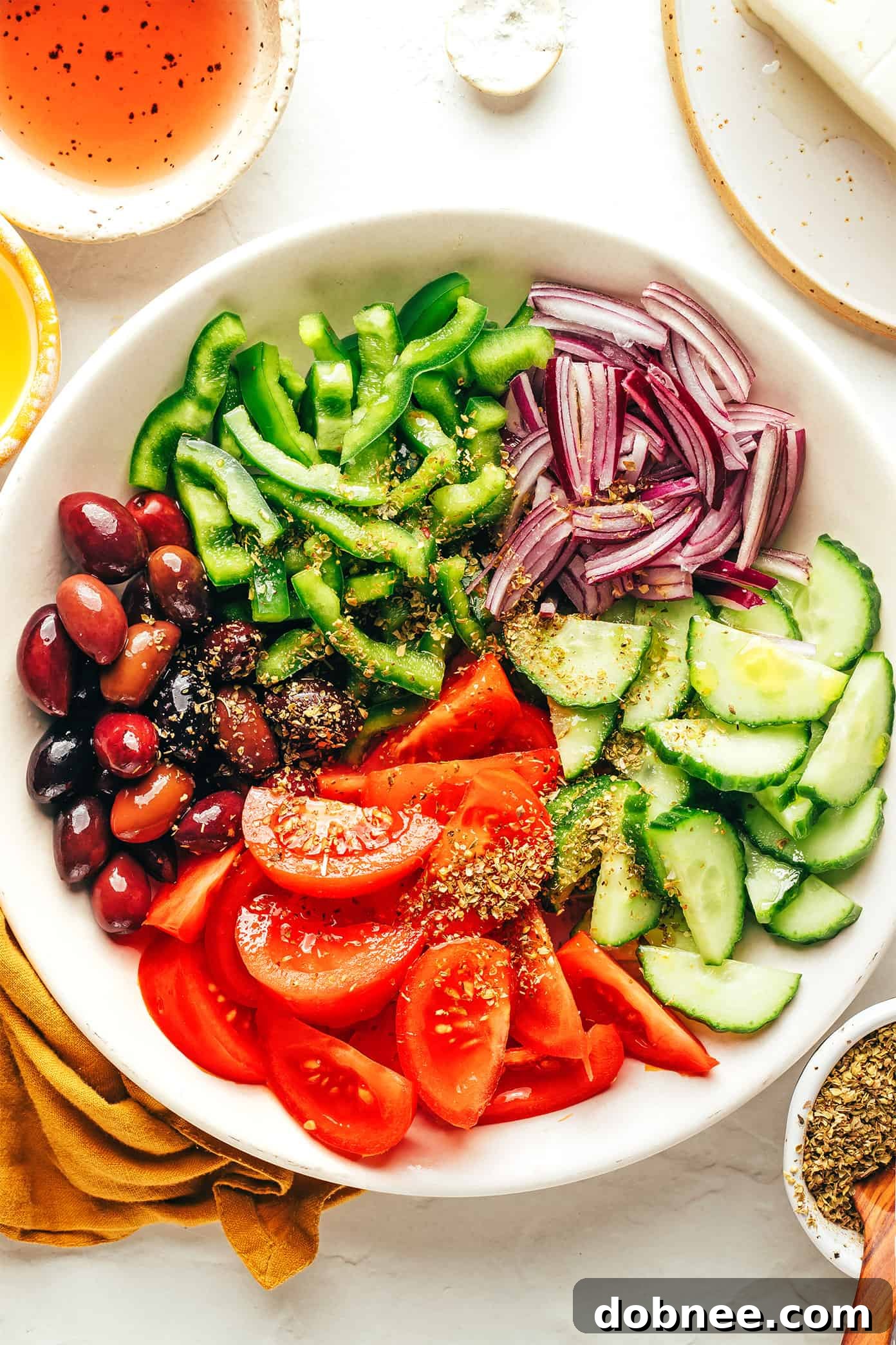 Bowl of authentic Greek Salad with a large block of feta cheese on top