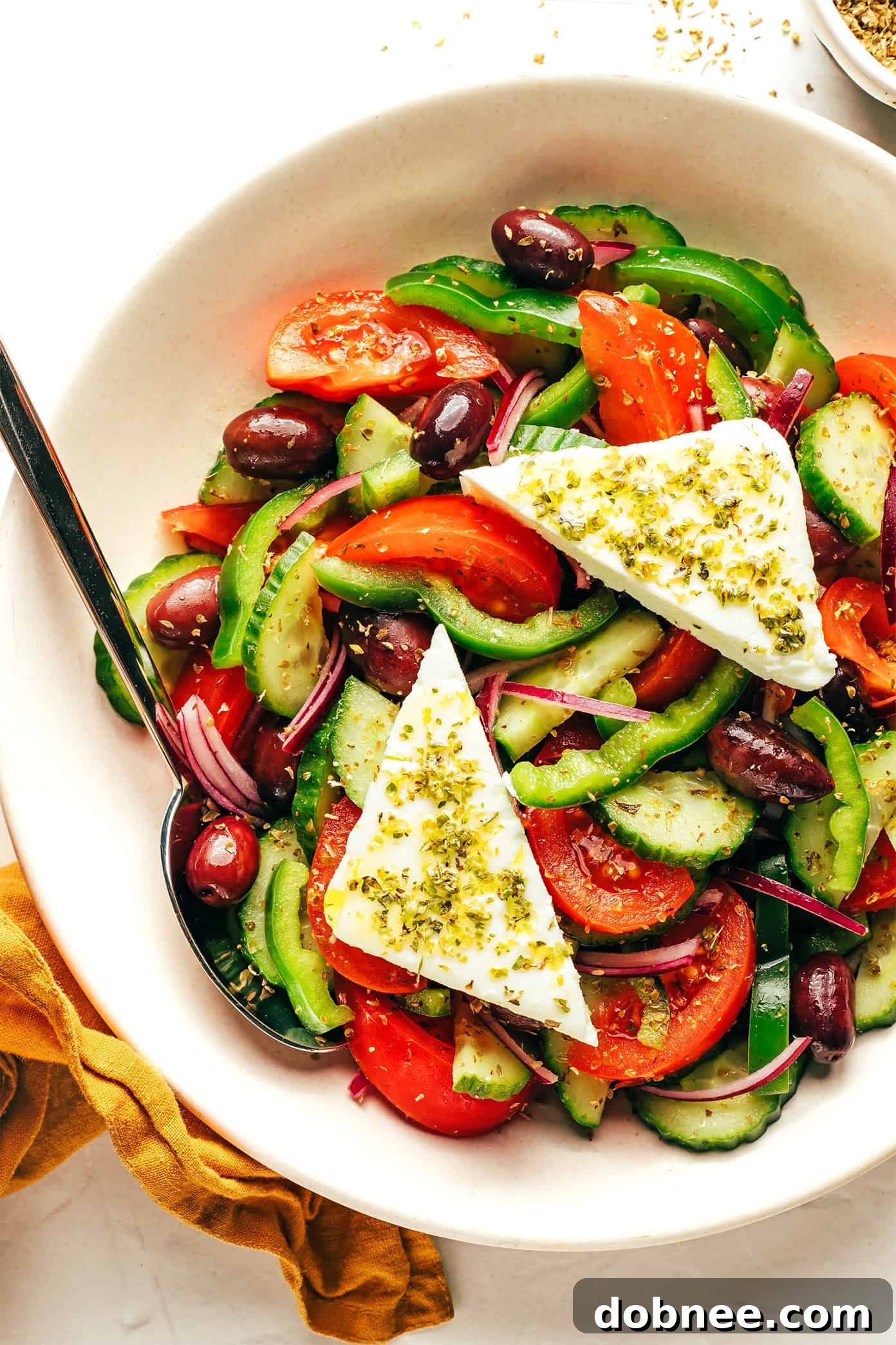 A serving of authentic Greek Salad alongside crusty bread