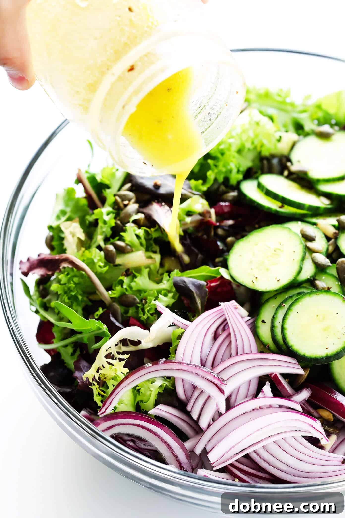 Adding lemon dressing to the everyday salad ingredients