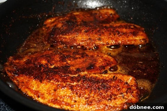 Blackened Tilapia Cooking in Skillet