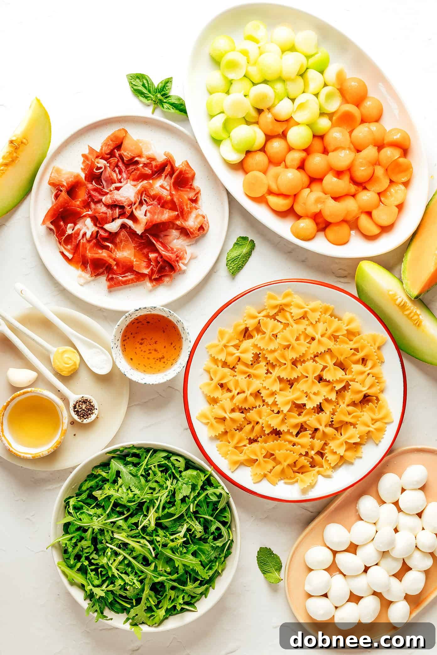 Melon Prosciutto Pasta Delight 3 Close-up of Prosciutto Melon Pasta Salad, showing the texture of prosciutto, melon, mozzarella, and farfalle pasta coated in dressing.