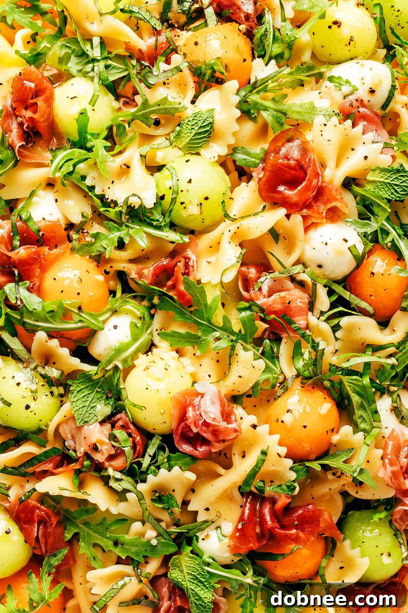 Melon Prosciutto Pasta Delight 5 A final close-up of Prosciutto Melon Pasta Salad, ready to be served, showcasing the fresh herbs as garnish.