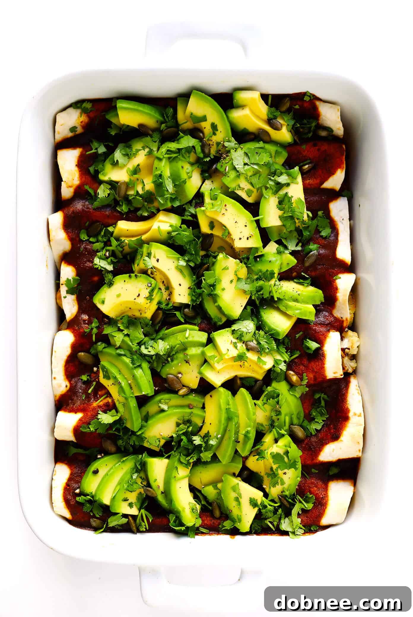 Roasted Cauliflower Enchiladas Recipe with Avocado and Cilantro Garnishes