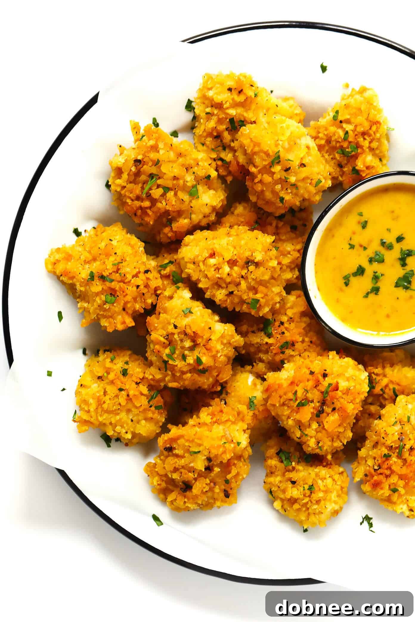 Ultra Crispy Baked Chicken Nuggets served with a side of honey mustard sauce