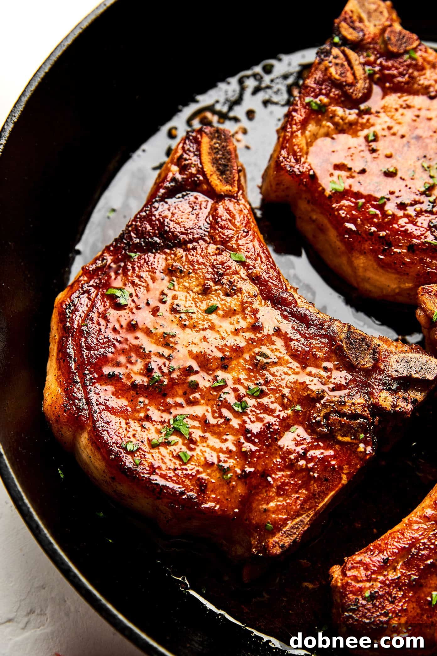 Close-up of a beautifully seared and baked pork chop, ready to serve.
