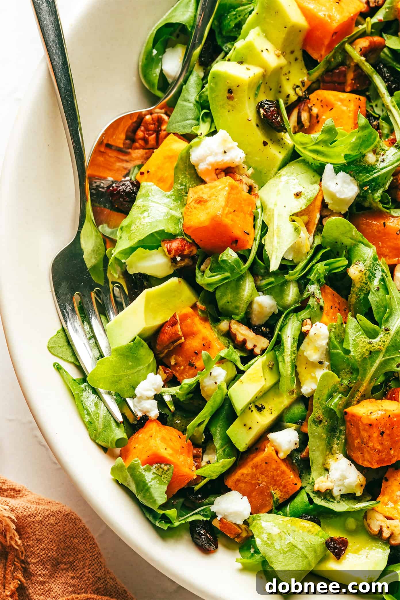 A close-up of the delicious Roasted Sweet Potato and Arugula Salad, highlighting the textures and vibrant colors of the ingredients.