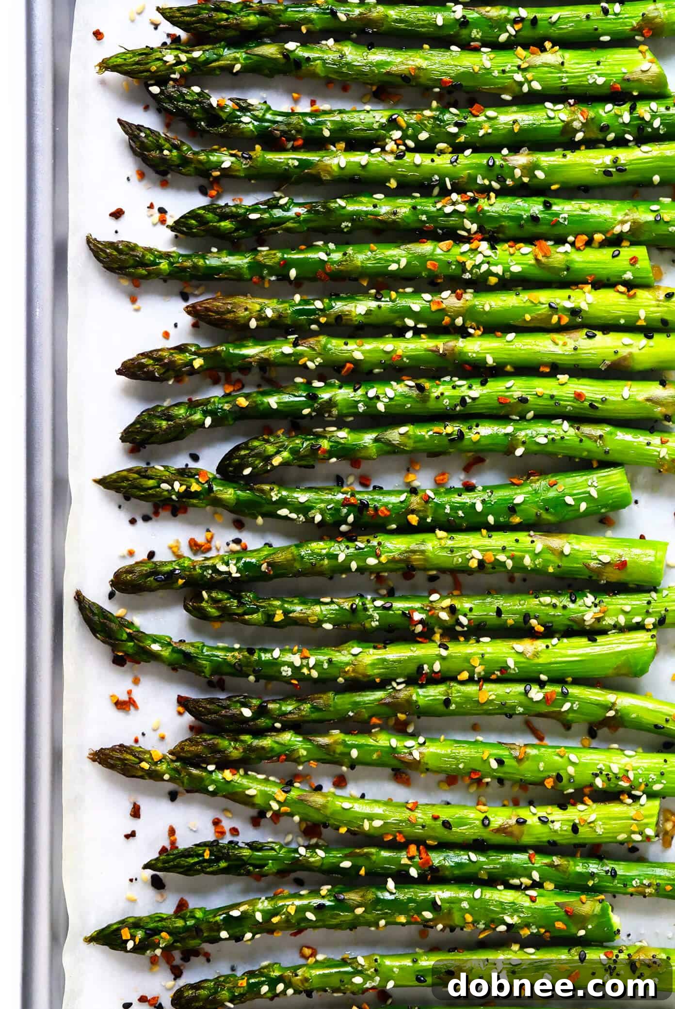 Kick your roasted asparagus recipe up a notch this season with some everything bagel seasoning! It's super quick and easy to make, naturally vegan and gluten-free, and makes the most delicious healthy side dish. Delicious "Everything" Roasted Asparagus Recipe, a healthy and easy side dish.